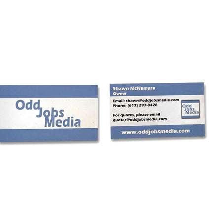 [photo] Front and back of an Odd Jobs Media cotton business card shown on a pure white background.