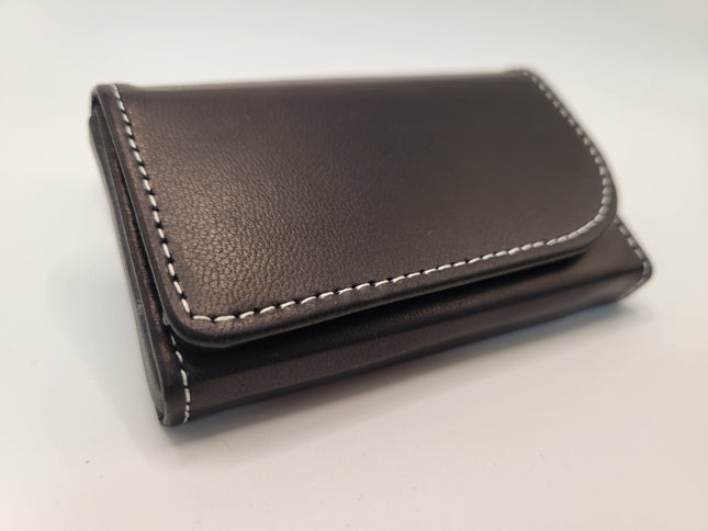 A dark brown leather wallet with white contrast stitching, shown closed on a plain light background.