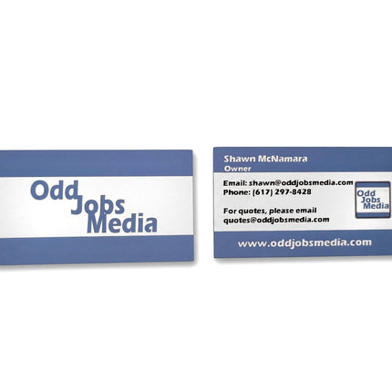 [photo] Two blue and white business cards for 'Odd Jobs Media' displayed side-by-side on a pure white background.
