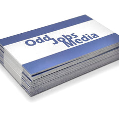 [photo] A stack of business cards with a blue and white design, featuring the text 'Odd Jobs Media' in blue, photographed on a pure white background.