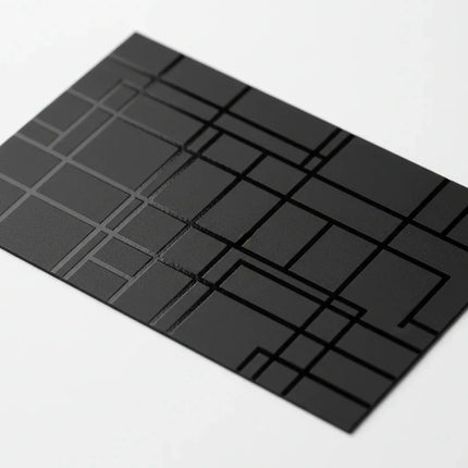 Black business card with geometric spot UV gloss design on white background