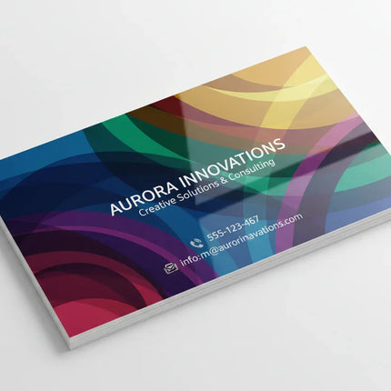 Colorful business card with glossy finish and abstract design on white background