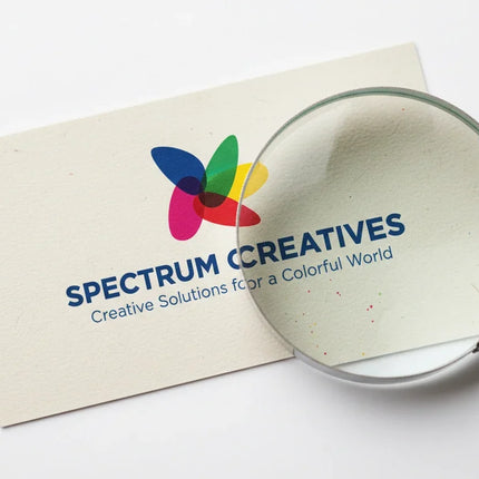 Colorful business card on natural stock with logo, magnified detail, white background