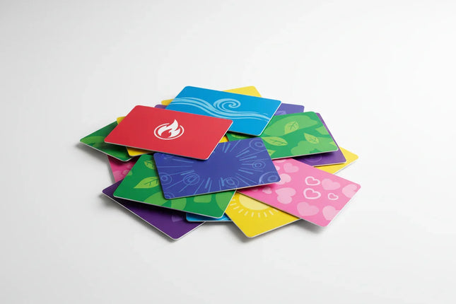 Colorful custom print gift cards with various icons piled on a white background