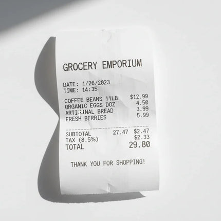 Thermal paper receipt with printed itemized grocery list on a white background