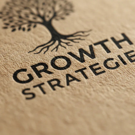 Close-up of a kraft business card with black tree design and bold printed text details.