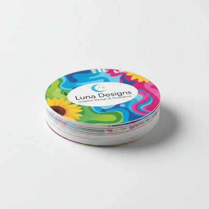 Stack of round, colorful business cards with floral design on white background