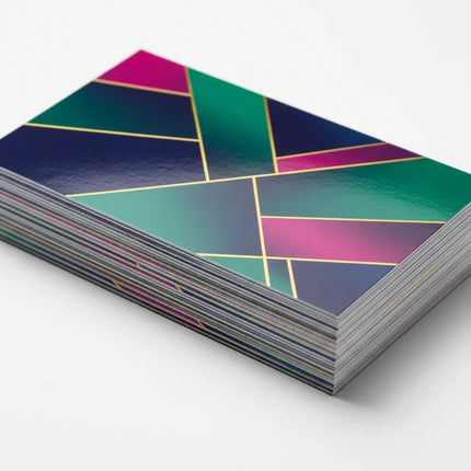 Stack of colorful business cards with UV coating and geometric design on white background