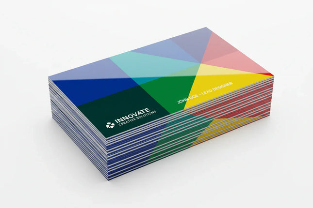 Glossy color business cards stacked on white background, custom printed design.