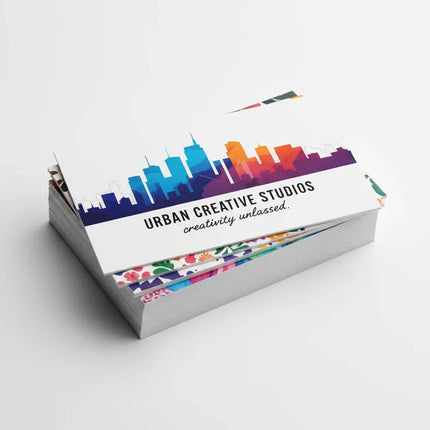 Stack of colorful matte business cards on white background, printed on 16-point cardstock