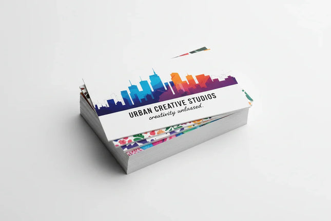 Stack of colorful matte business cards on white background, printed on 16-point cardstock