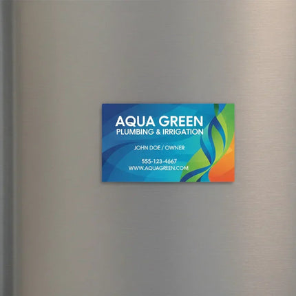 Colorful rectangular magnetic business card on silver metal fridge door