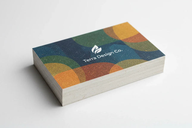 Stack of colorful business cards on natural textured stock with geometric design