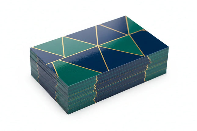Stack of custom printed business cards with geometric design, glossy coating on white background