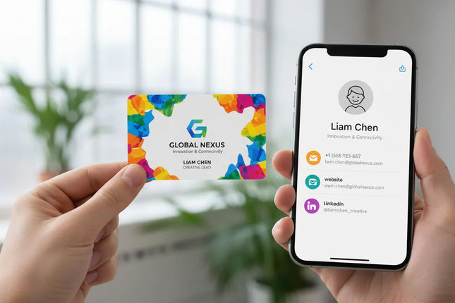 Custom printed white plastic business card held near smartphone displaying digital contact info.