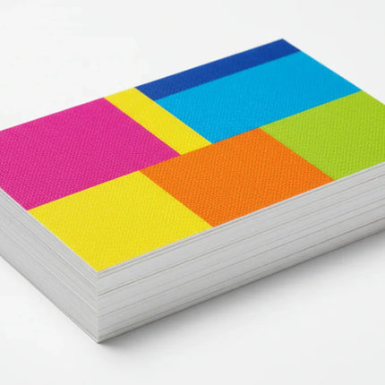 Stack of colorful rectangular business cards on 13pt linen stock, white background