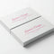 Stack of rectangular business cards with pink print on pearl paper, white background