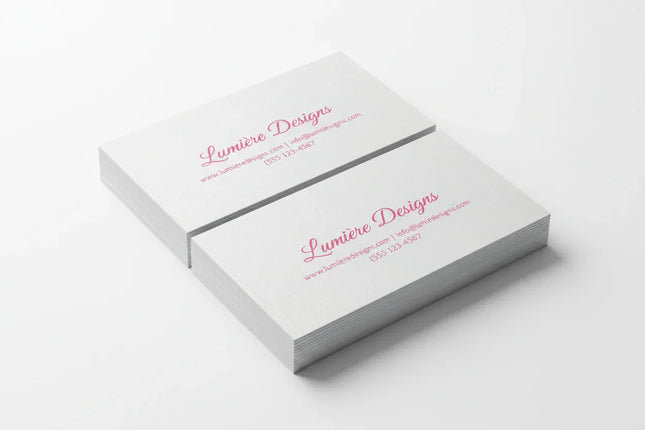 Stack of rectangular business cards with pink print on pearl paper, white background