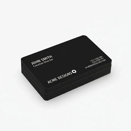 Stack of custom black business cards with white text on clean background