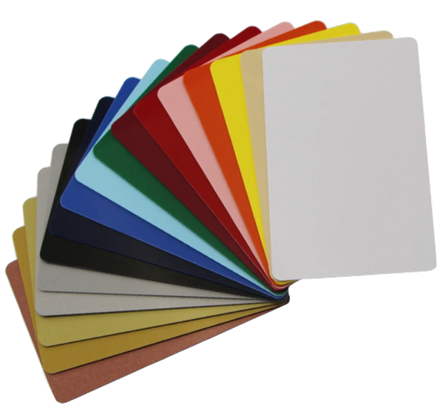 Assorted blank plastic ID cards in various colors fanned out on a white background.