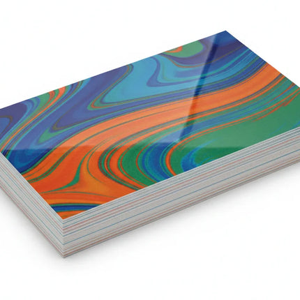 Stack of 18pt thick glossy business cards with colorful abstract design on white background
