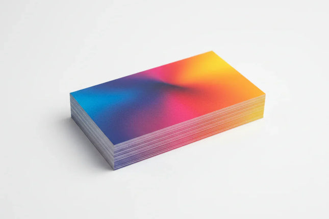 Stack of rectangular matte laminated business cards with colorful gradient design on white background