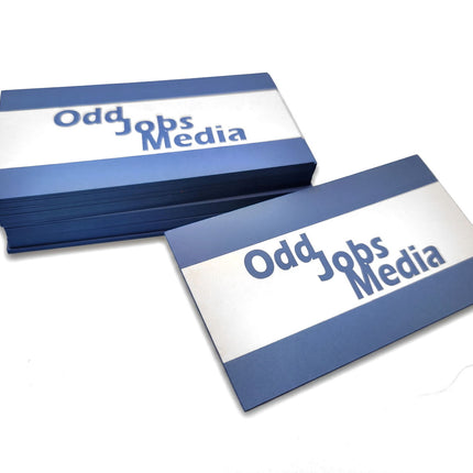 [photo] A stack of rectangular business cards with blue and white horizontal stripes and the text 'Odd Jobs Media' printed on a pure white background.