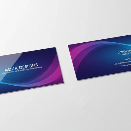 Two high gloss laminated business cards with colorful wave design on white background