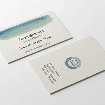 Two color-printed business cards on uncoated linen stock, front and back, on white background.